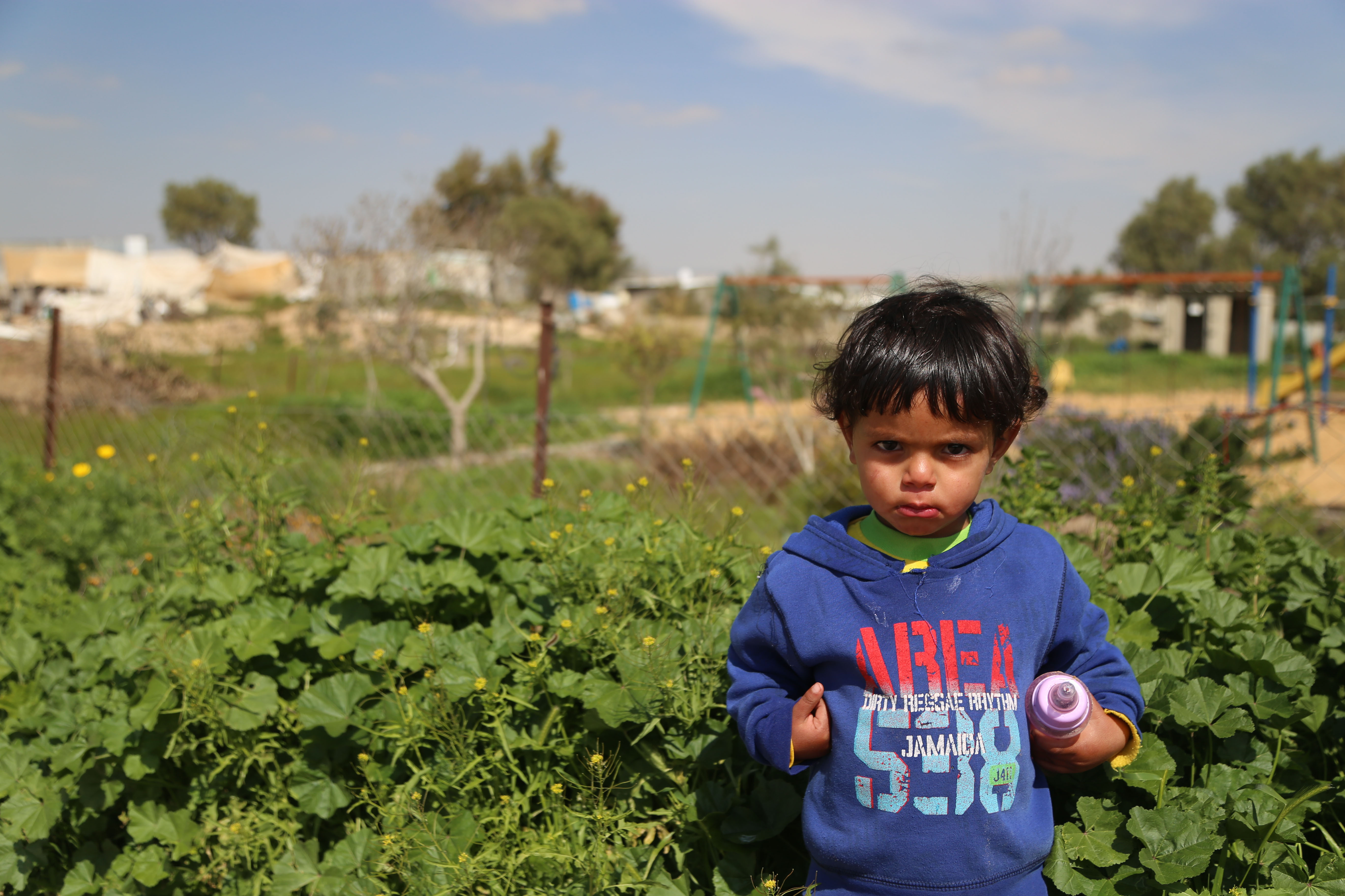 A boy stands outside the unrecognized Palestinian village of Khashem Zaneh.