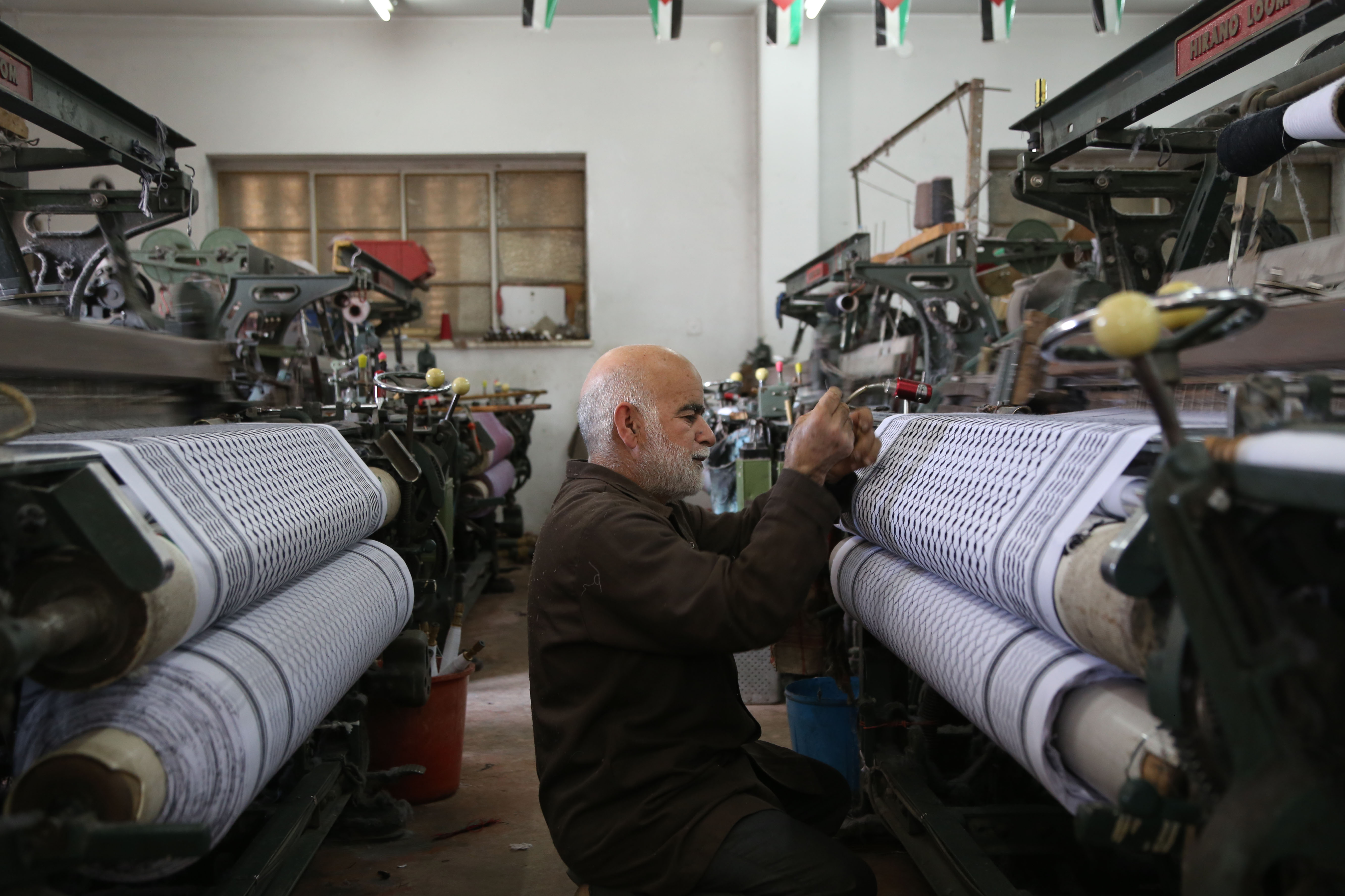Abu Yaqub has been working in Hebron’s keffiyeh factory, Hirbawi, for 46 years. Hirbawi is the last remaining keffiyeh factory in Palestine, struggling to remain open in the face of cheap imports. Since as early as the 1930s, the keffiyeh has been a symbol of Palestinian pride and solidarity.