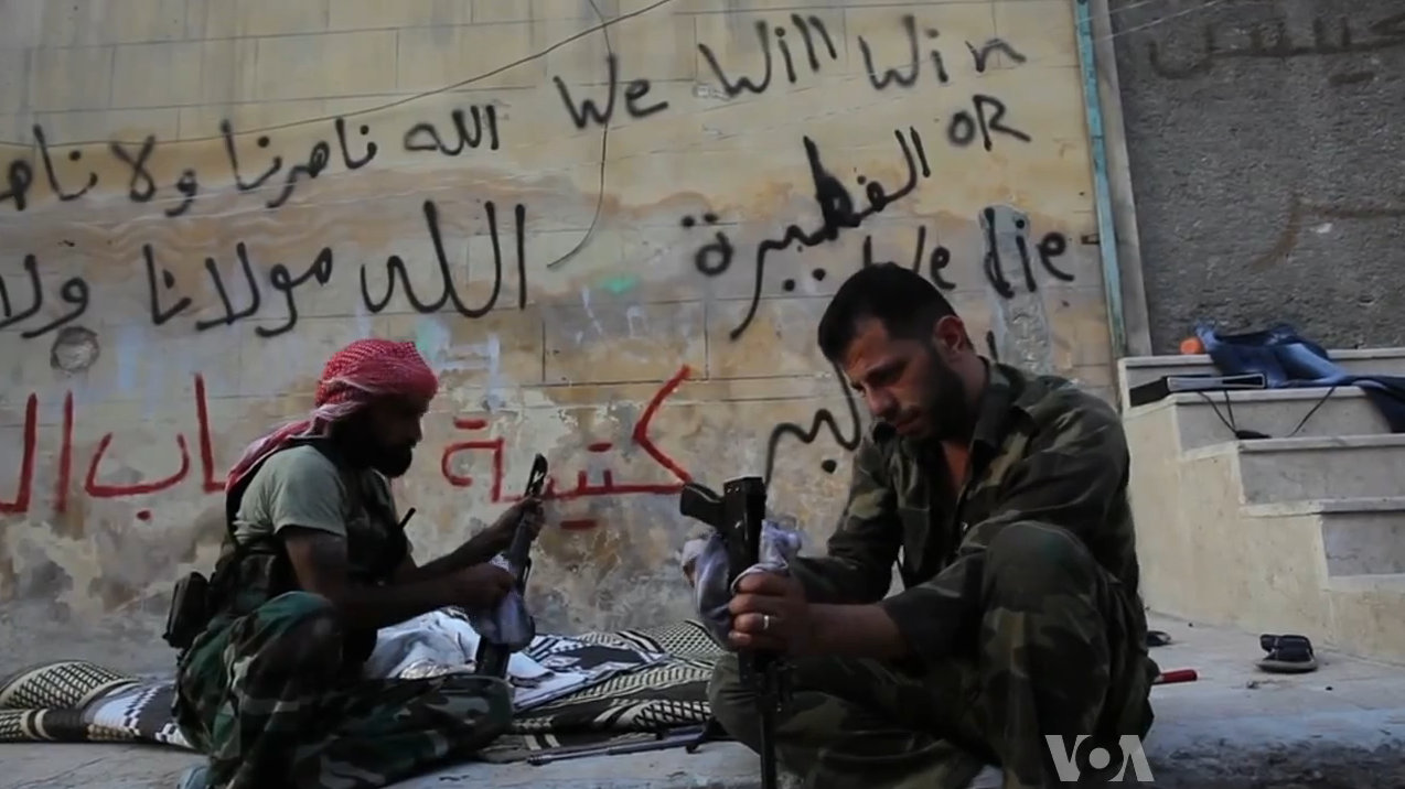 Free Syrian Army rebels cleaning their AK47s, Aleppo, Syria, 2012. (WikiCommons)